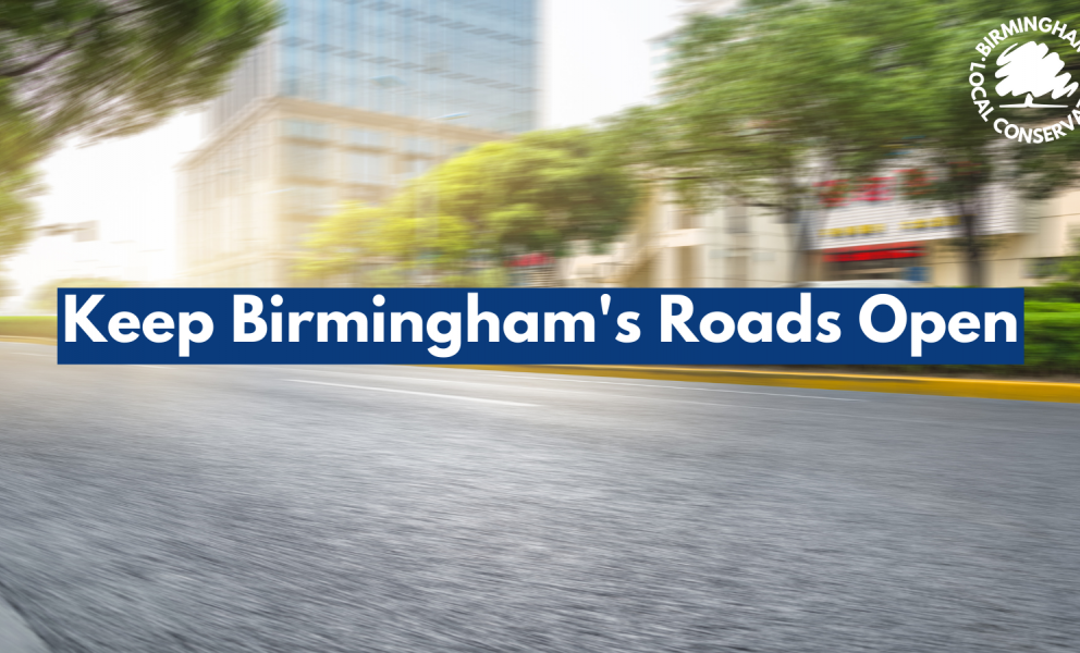 A blurred picture of an open road through a city centre. Text with a blue underlay reads, Keep Birmingham's roads open.