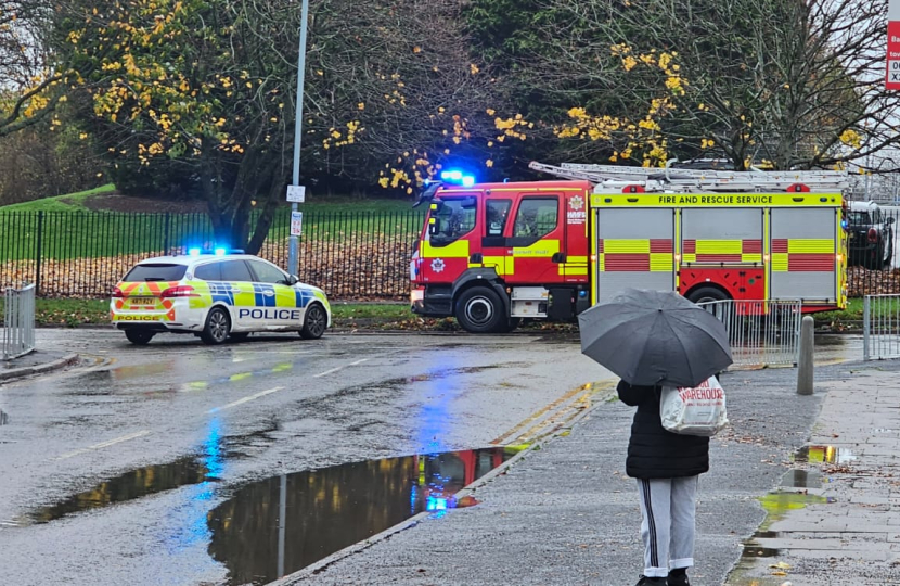 Flooded road with Fire service and police in attendance