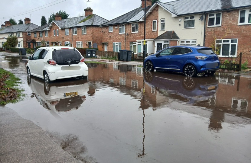 Flooded road with cars driving through